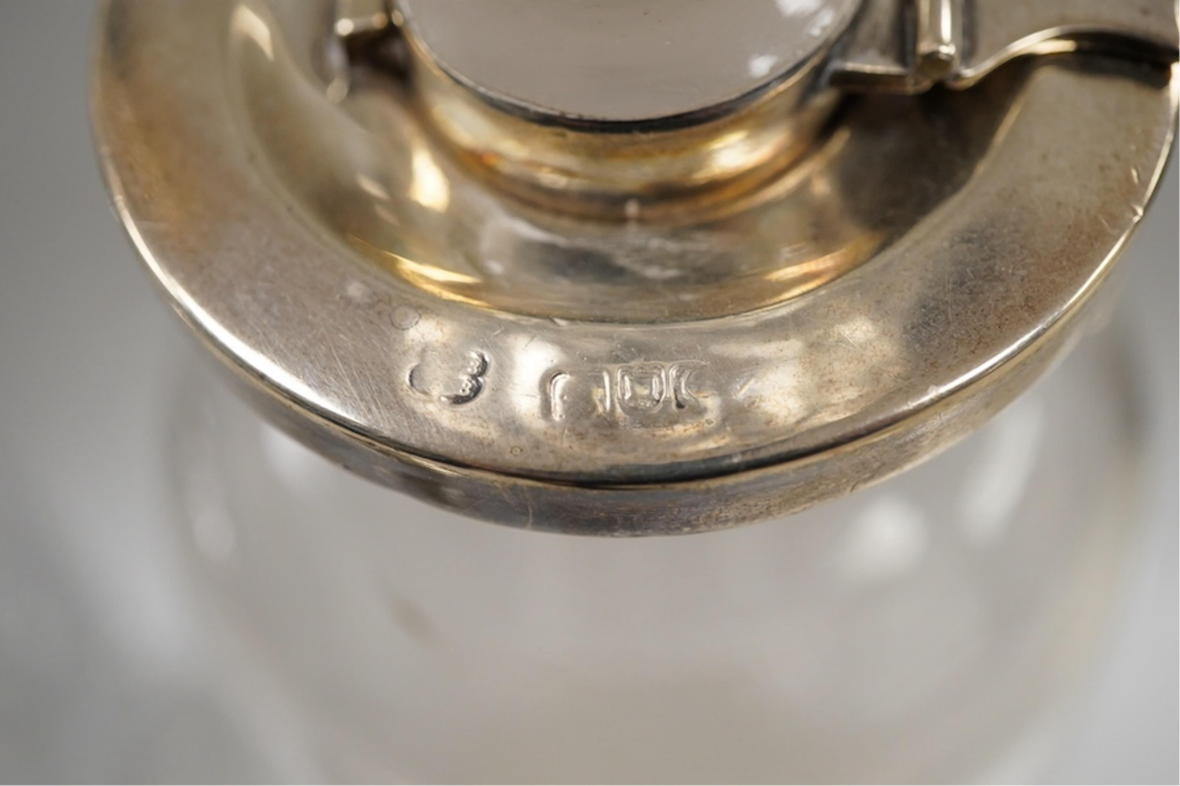 Three assorted silver mounted cut glass decanters, including two modern and one earlier with lock, marks rubbed, no key, the latter 34.1cm.